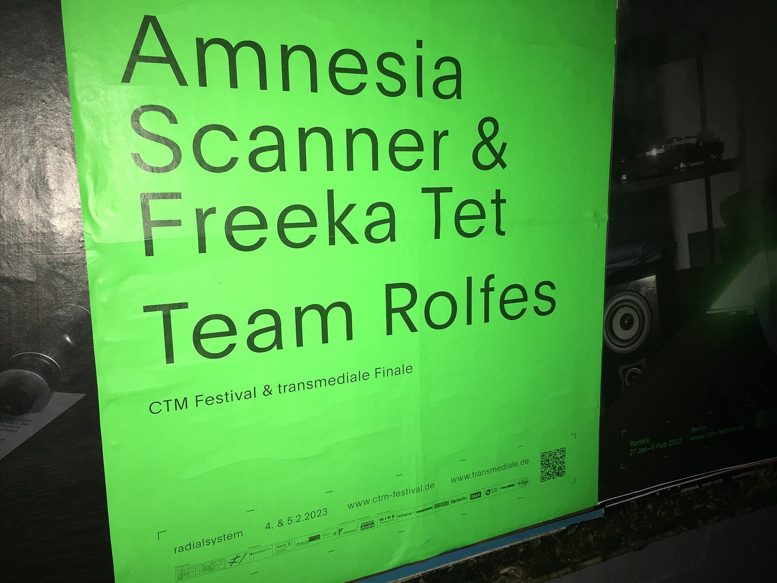 Зелёная афиша CTM Festival 2023 с Amnesia Scanner на стене в Берлине